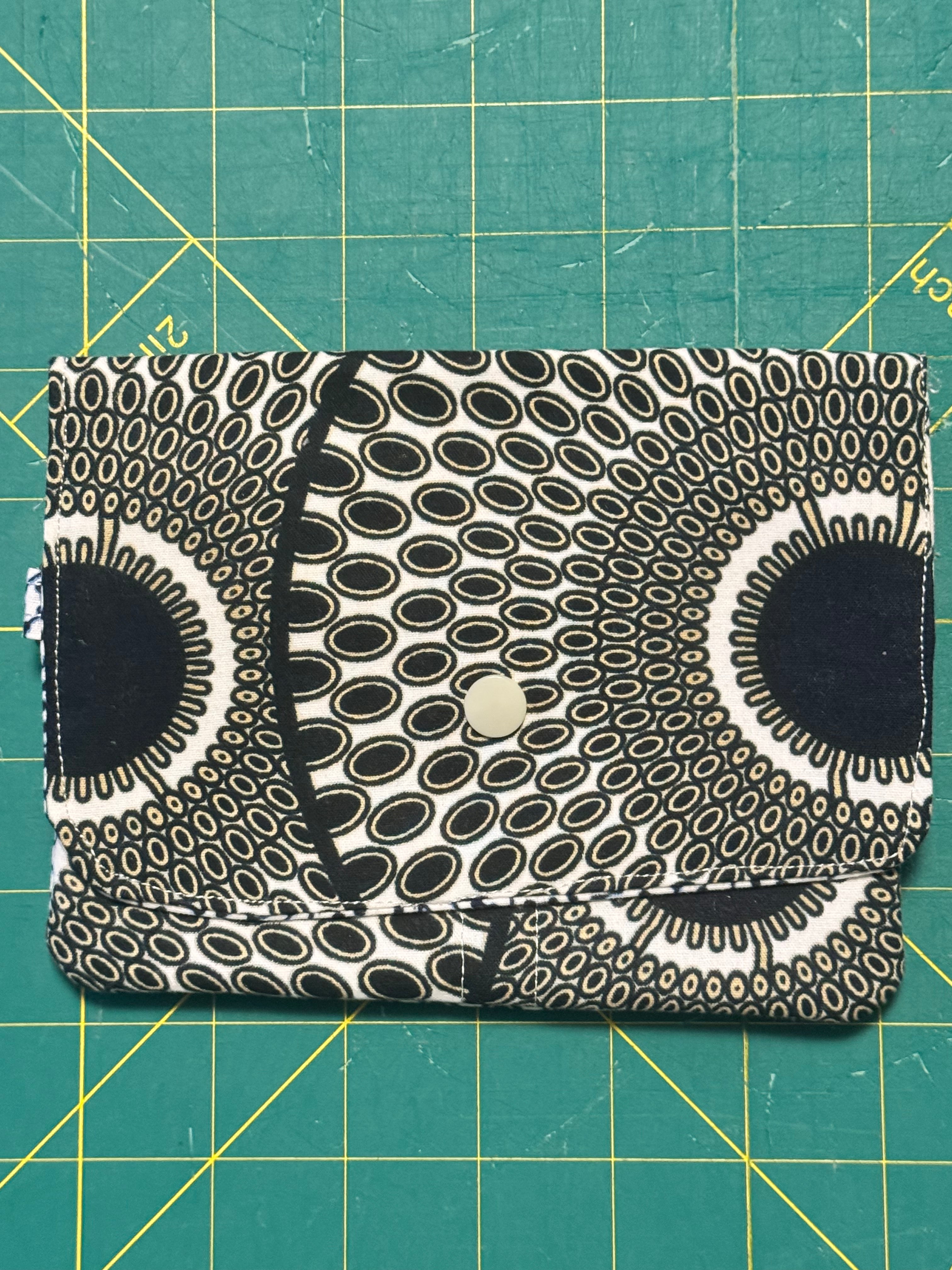 Ankara snap travel wallet – black and white honeycomb print with pink circle and striped base