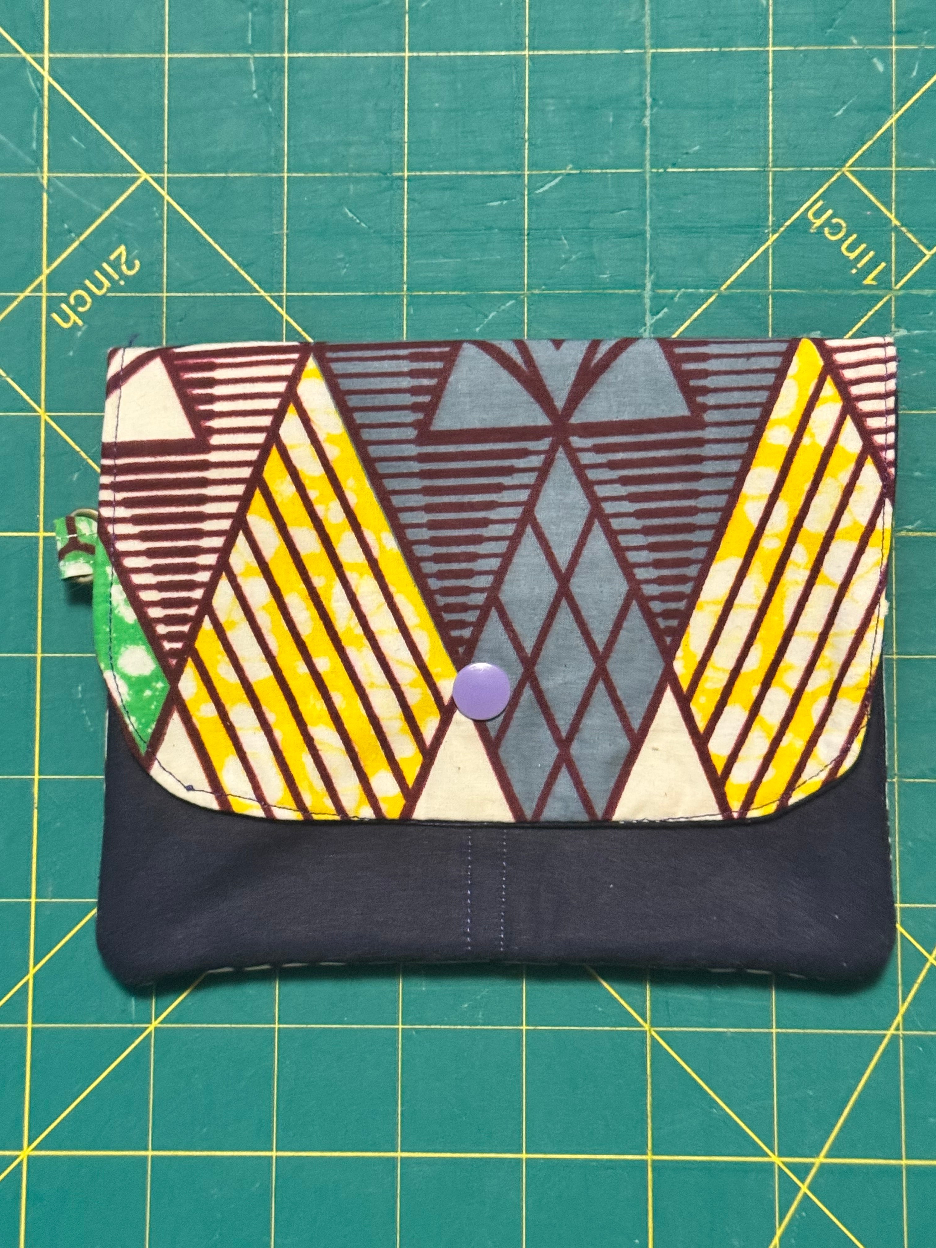 Collection of four Ankara snap travel wallets in assorted bold prints